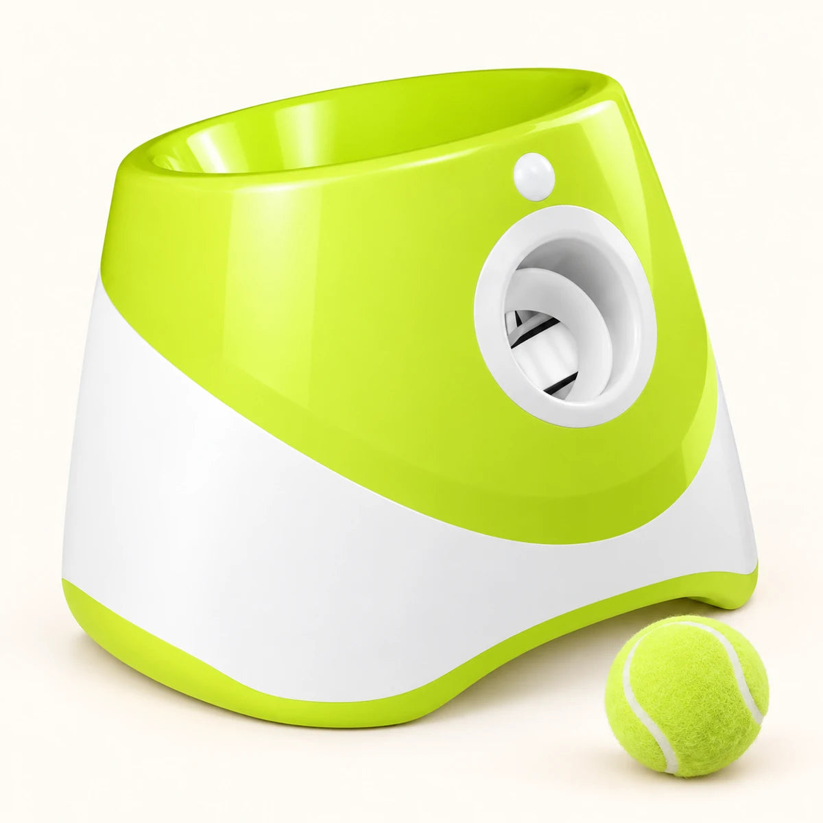 Green automatic dog ball launcher with top-loading opening, white front outlet and green ball on a clean cream background