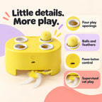 Yellow four-opening cat teaser box with ball and feather attachments with labeled product features