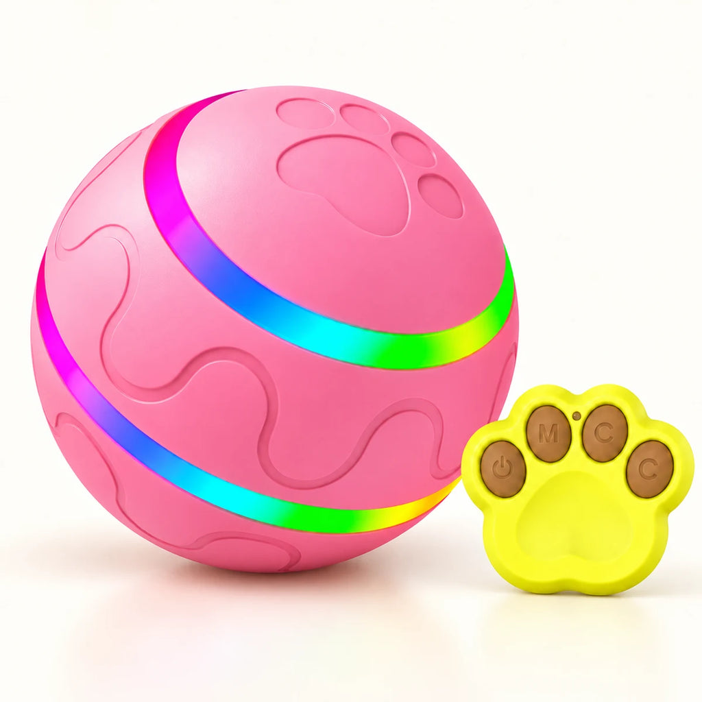 Pink USB rechargeable dog ball with embossed paw details, two rainbow LED bands and a yellow paw-shaped remote